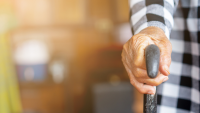 Person holding cane.